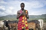 Masai man holding smartphone.